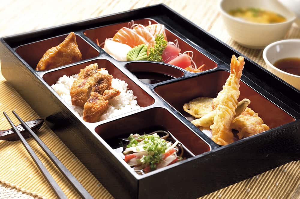 A bento box with a variety of Asian food.