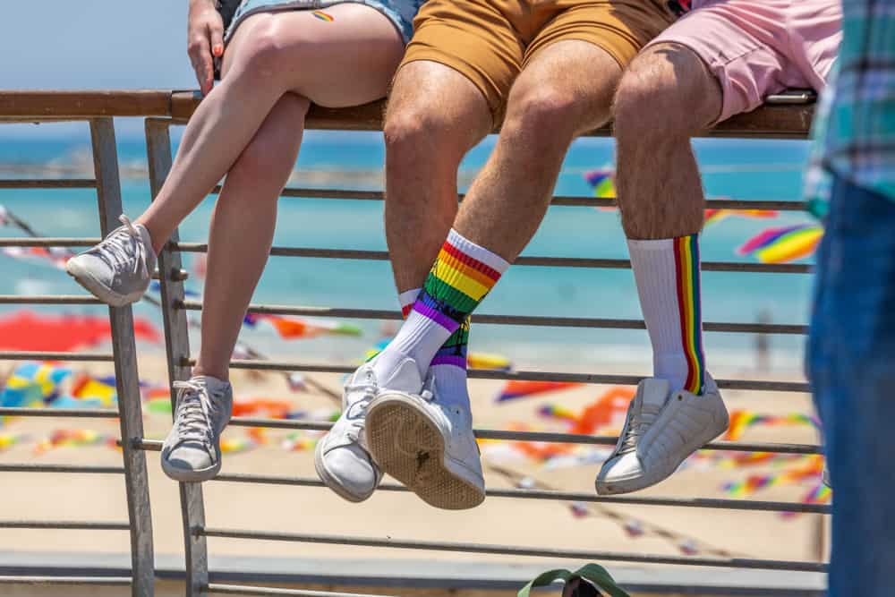 A group of people sat by a beach in an article about gay beaches about Florida