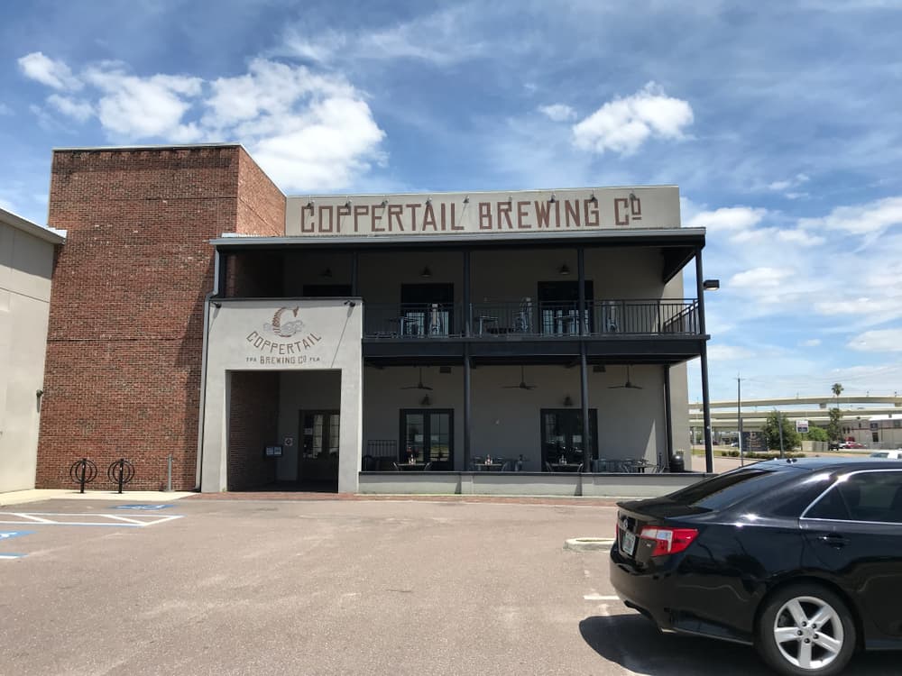 The exterior of Coppertail Brewing Co, including a covered balcony, located in downtown Ybor.