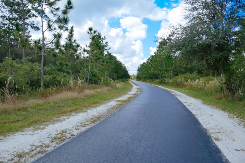 A paved bike path cuts through Flatwoods Park Trail, a ride or hike on which is one of the best things to do Central Florida.