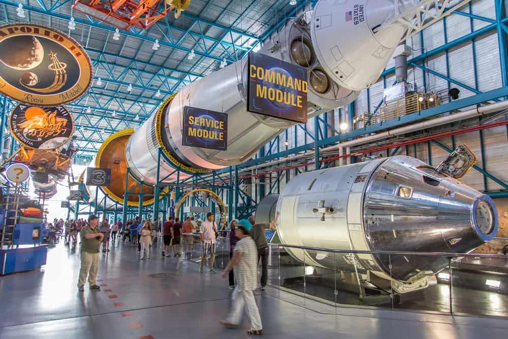 People walk around the high-ceilinged interior of NASA Kennedy Space Center Museum in Cape Canaveral, one of the most popular things to do in Central Florida.