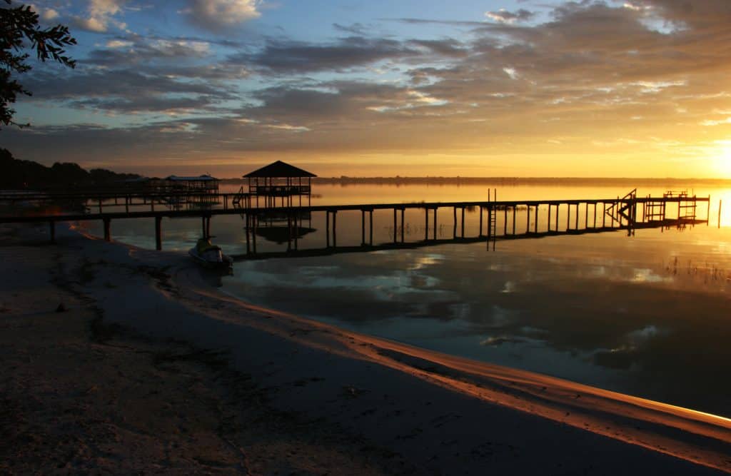 The sun sets over the still waters of Lake Placid, Florida.