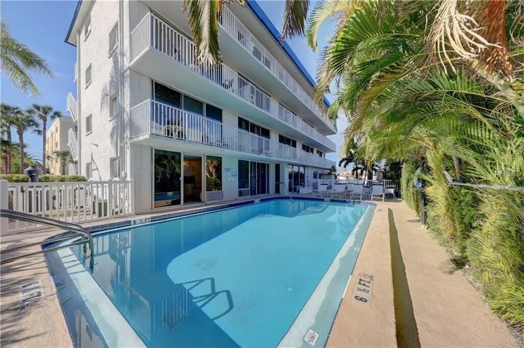 Photo of the exterior of a condo building in Clearwater that is poolside.