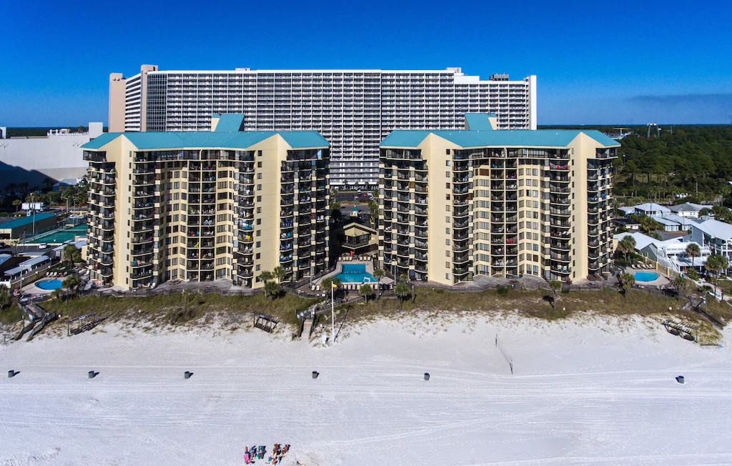 Photo of a large beachfront condominium building that is home to a VRBO in Florida. 