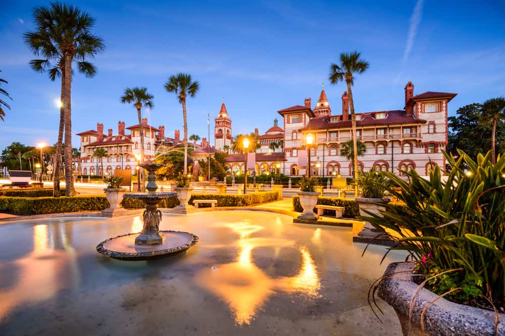 A beautiful Spanish style building in St Augustine with a fountain in the foreground. 