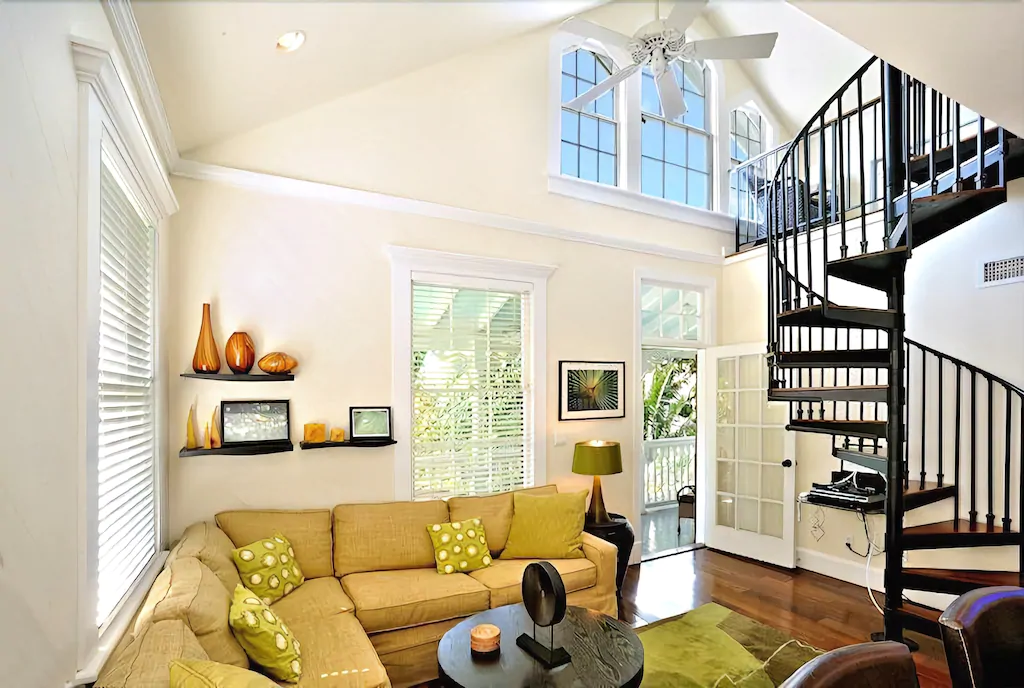 Photo of a living room featuring a spiral staircase inside a VRBO in Key West.