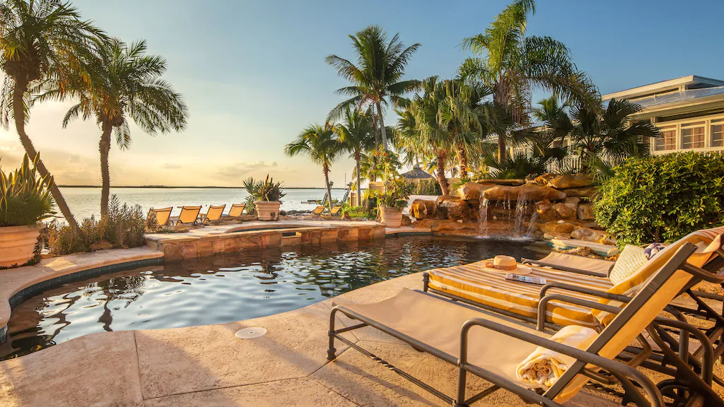Photo of an oceanfront pool with a spa and waterfall that is located in Key West.
