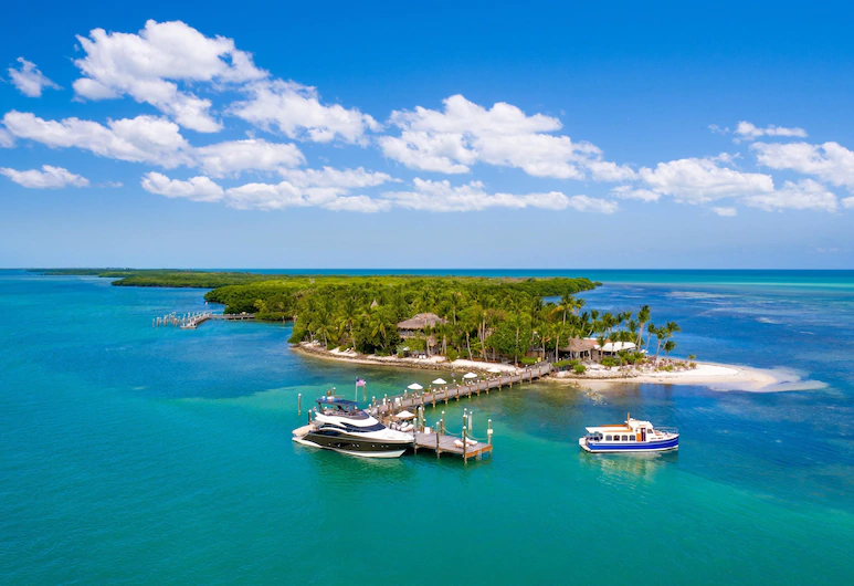 Aerial view from above of Pal Island with boats in dock one of the all inclusive hotels in Florida.