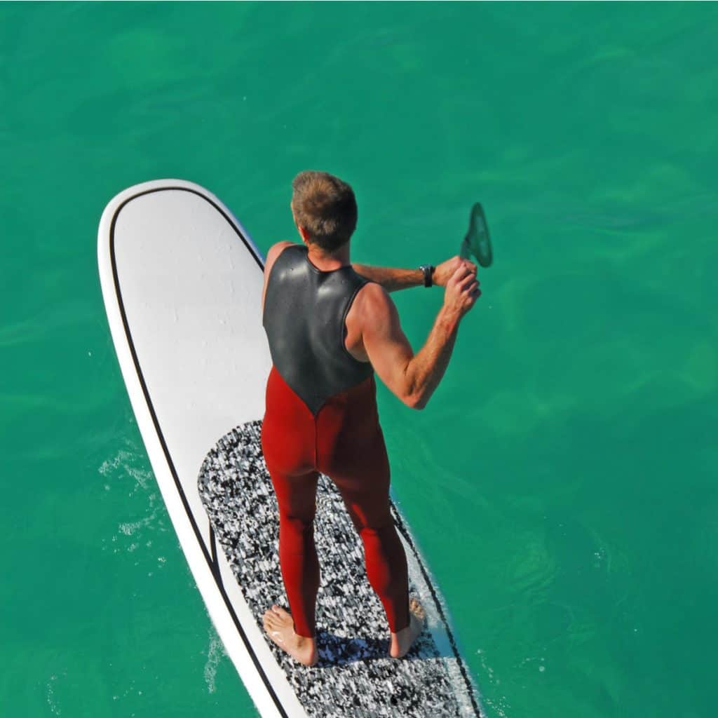 MAN STANDUP PADDLE BOARDING AT QUIETWATER BEACH IN PENSACOLA