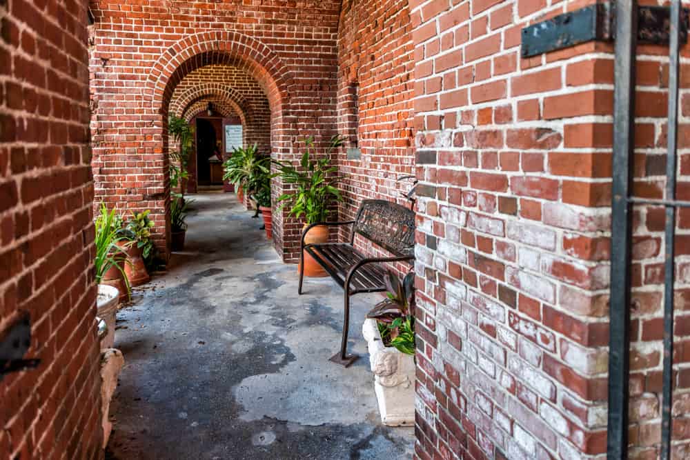 A brick path in Key West Garden Club at Martello Tower, one of the most unique botanical gardens in Florida.