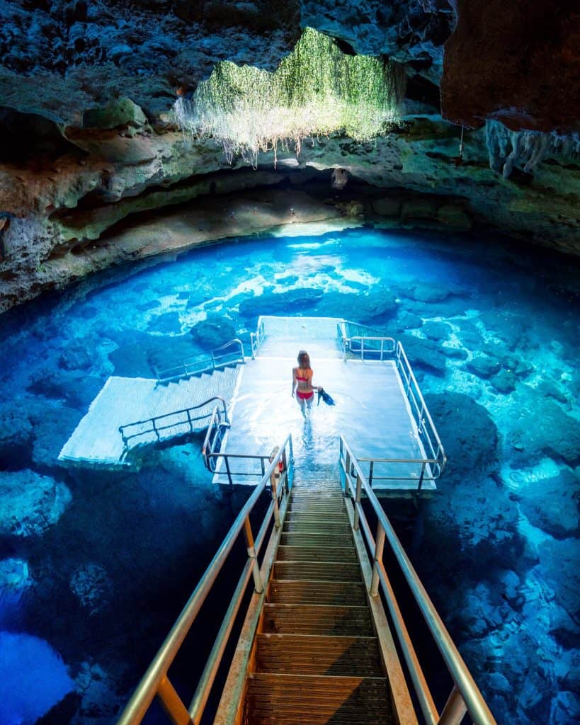 Girl snorkeling within cave at one of florida springs near Gainesville
