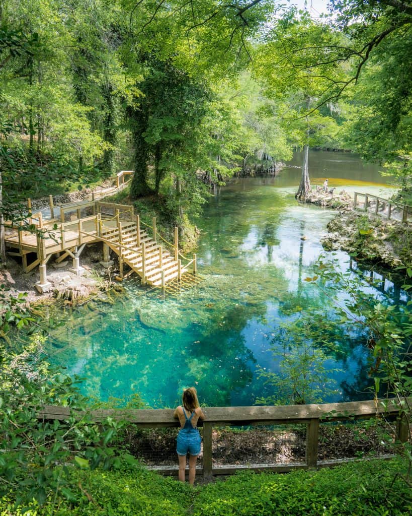 Girl beside stairs overlooking natural crystal clear springs near Tallahassee, florida 