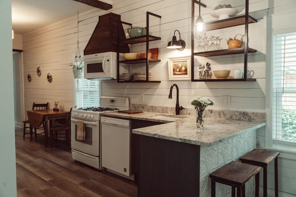 Inside the remodeled downtown cottage, one of the best airbnbs in pensacola, you'll find updated appliances in a gorgeous kitchen with granite countertops