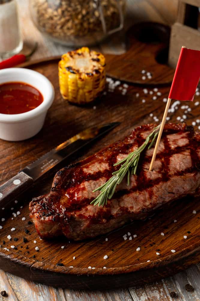 Vinny McGuires serves up a steak with roasted corn