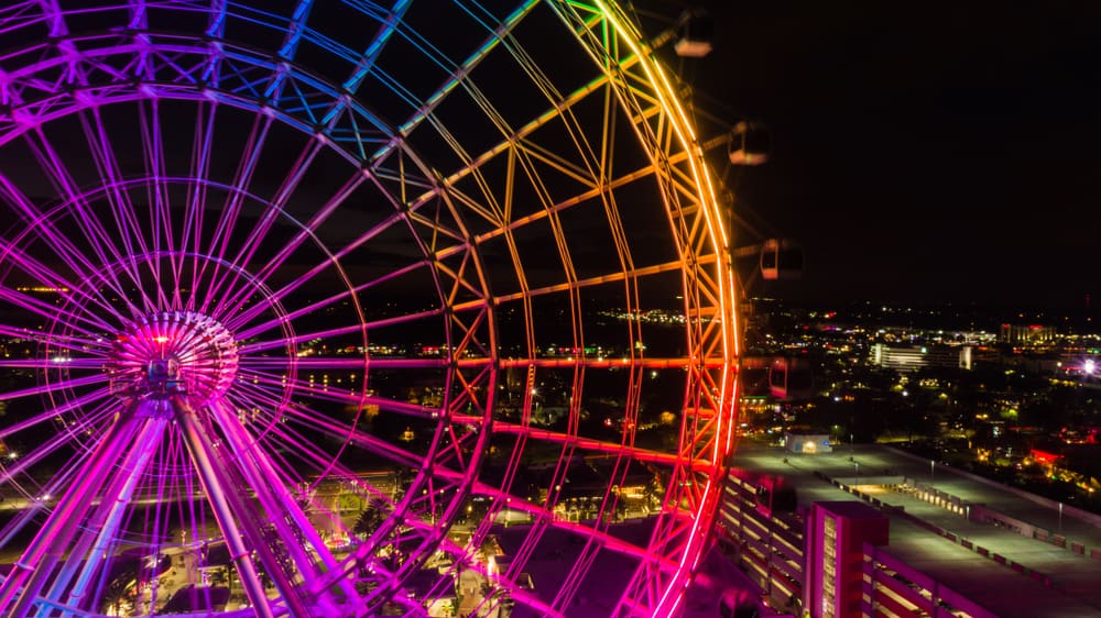 orlando eye at night lit up in rainbow lights