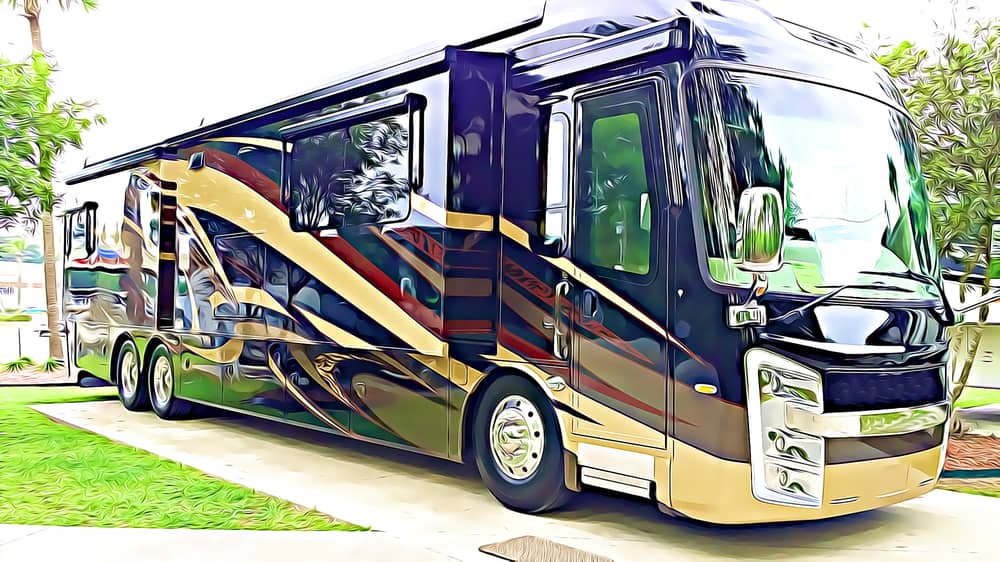 A black and gold class A motorhome on a concrete slab at an RV park