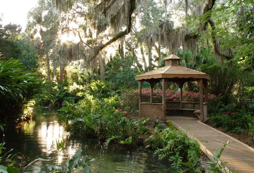 Gazebo hangs beside water in reflection garden at one of the best day trips in Florida
