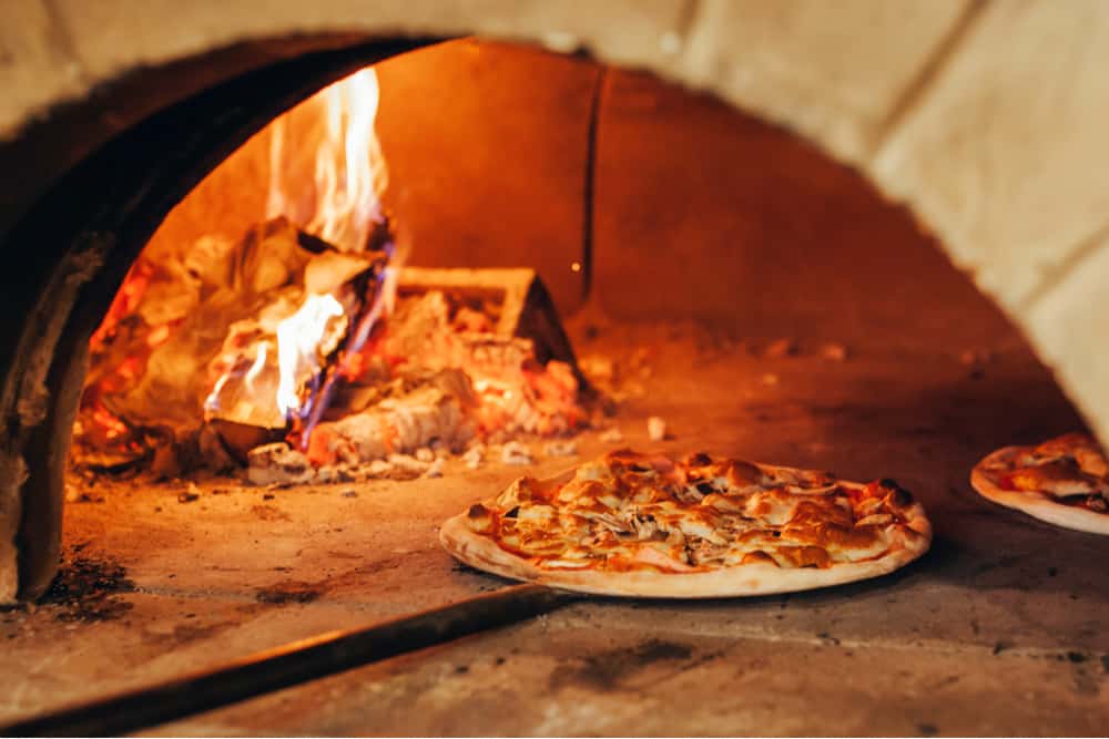 Wood coals heat up the pizza for a slighty crispy crust
