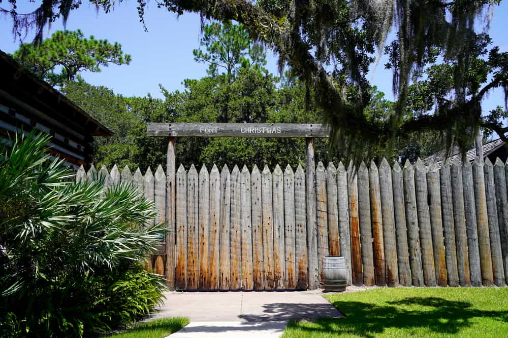 log wall at Fort Christmas with trees