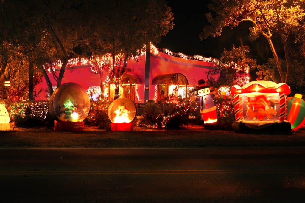 An elaborate Christmas display outside a house on a dark road