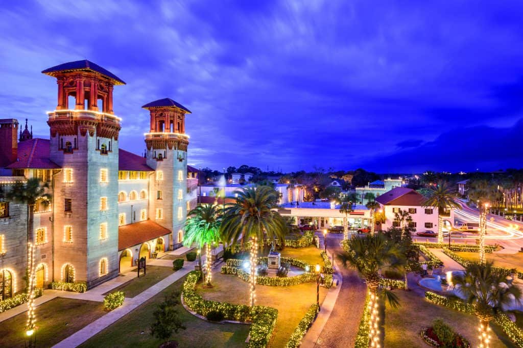 A park lit up for Christmas within a Christmas town in Florida with a blue sky