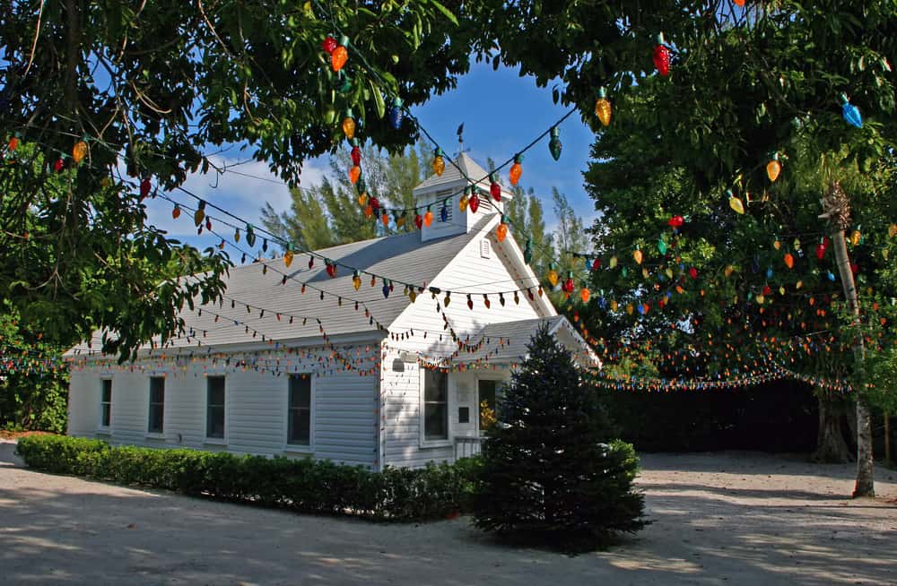 This white chapel is small and decorated with colorful lights.