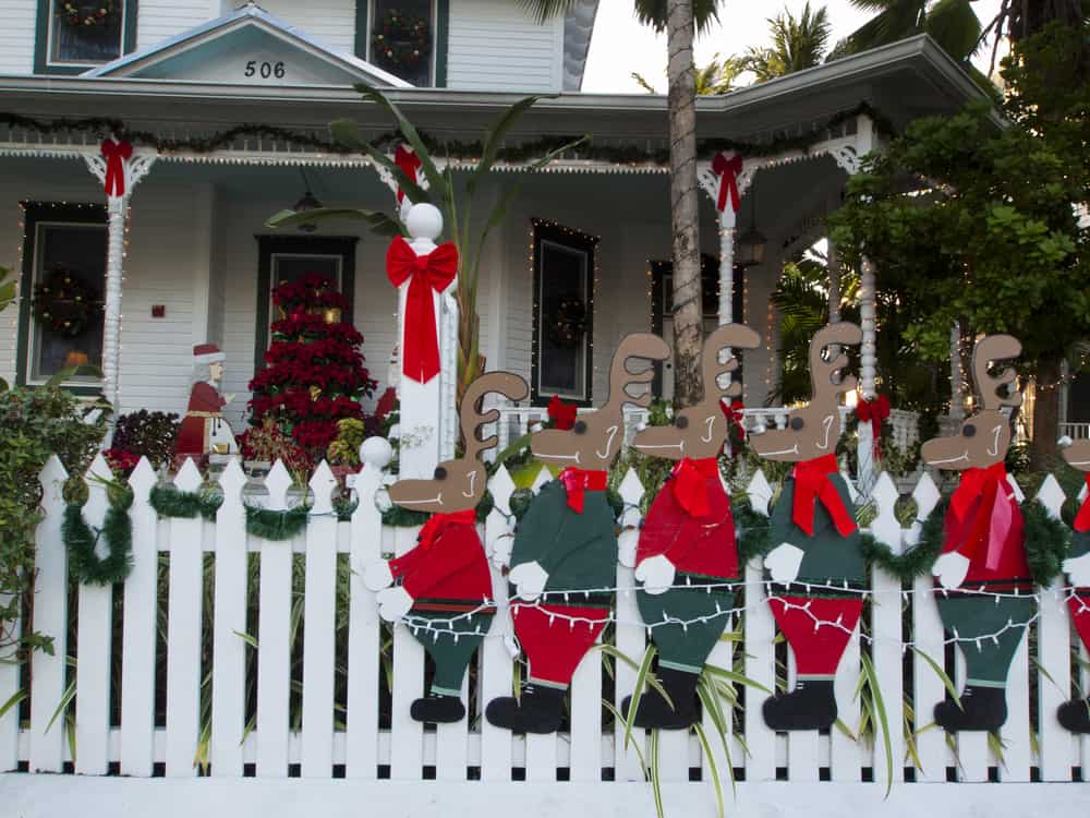 A resident't front yard is decorated for Key West in December with lots of raindeer!