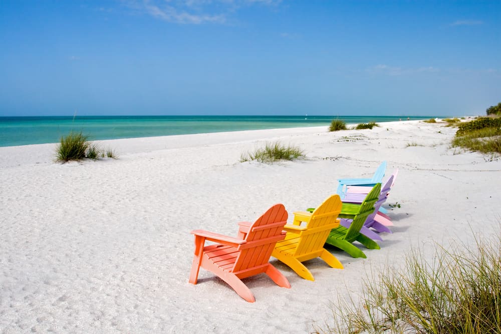 Colorful chairs on Captiva Island, one of the best beaches in Fort Myers for boat tours.
