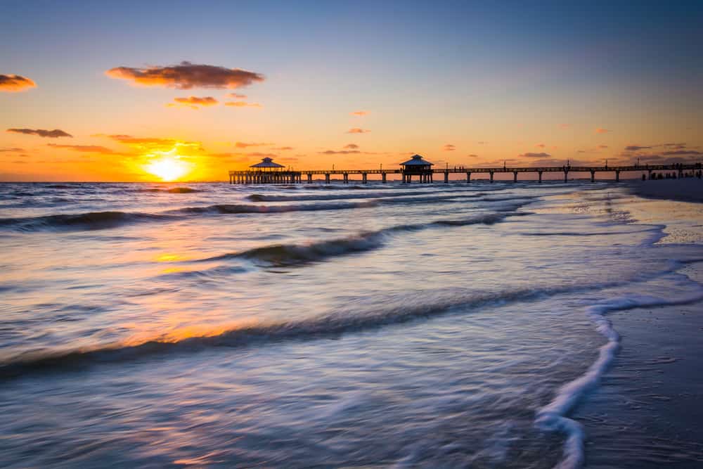 Photo of the sunset over Fort Myers Beach with the fishing pier in the distance.