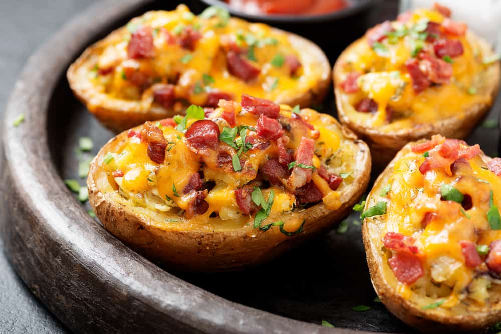 a wooden plate with several loaded potato skins at one of the best restaurants on anna maria