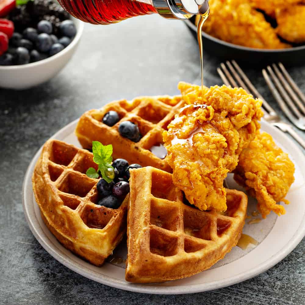 Chicken and waffles with maple syrup at one of the best restaurants in Miami for brunch, Root & Bone.