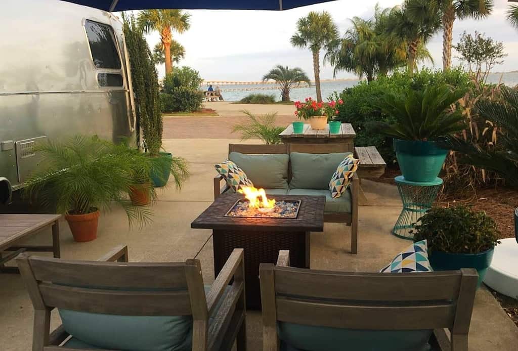 The outdoor firepit with a view of the airstream and ocean, one of the best places for glamping in Florida. 