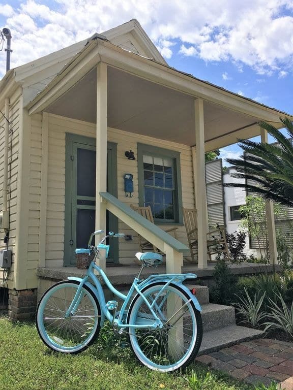 THis beautiful Pensacola Florida Cottage with a teal bike in foreground