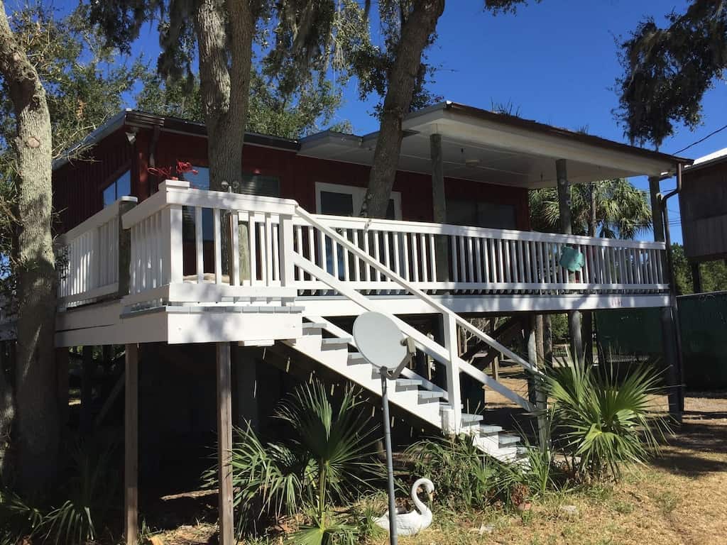 Head back to old florida with the white rails of this red treehouse