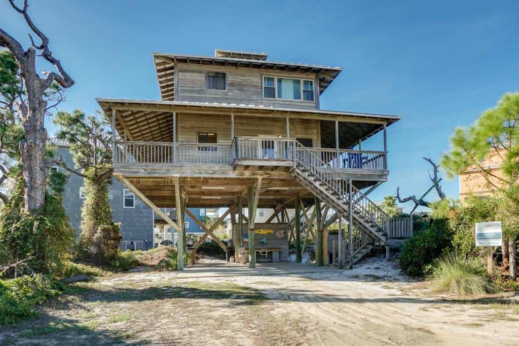 THis three level wooden treehouse is located on a sandy beach along the Florida Panhandle