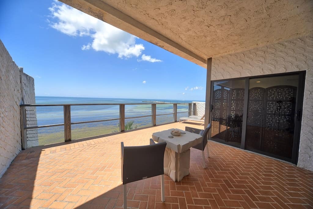 The impressive view of the Atlantic from Casa Atlantica. Two chairs look out from the glorious sunny patio. 