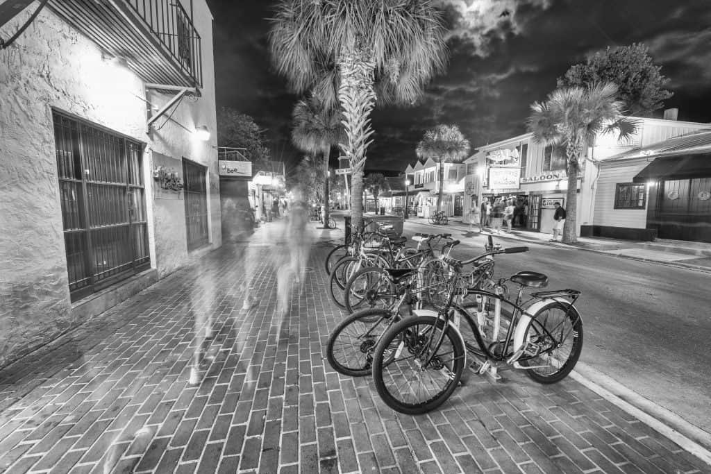 A long exposure black and white shot of people walking down Duval Street giving them a ghostly appearance