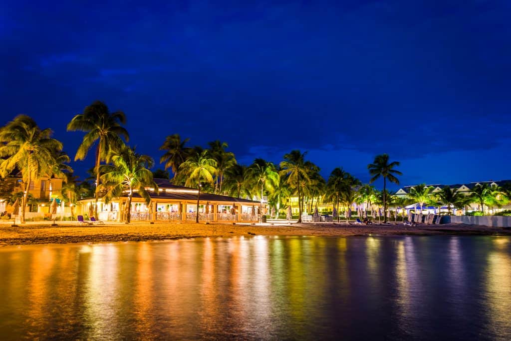 a nighttime shot of the beach in key west from the ocean's point of view 