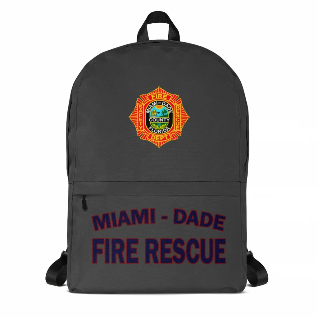 A picture of a grey backpack with the crest of the Miami-Dade county fire rescue on it, featuring the words "miami-dade fire rescue" in blue and red on a white background. One of the best Miami gifts!
