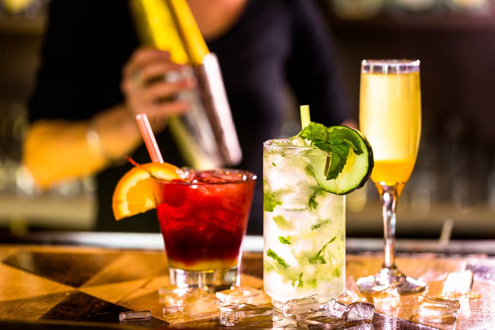 Three different colorful cocktails on the bar at Primrose Restaurant in Destin.