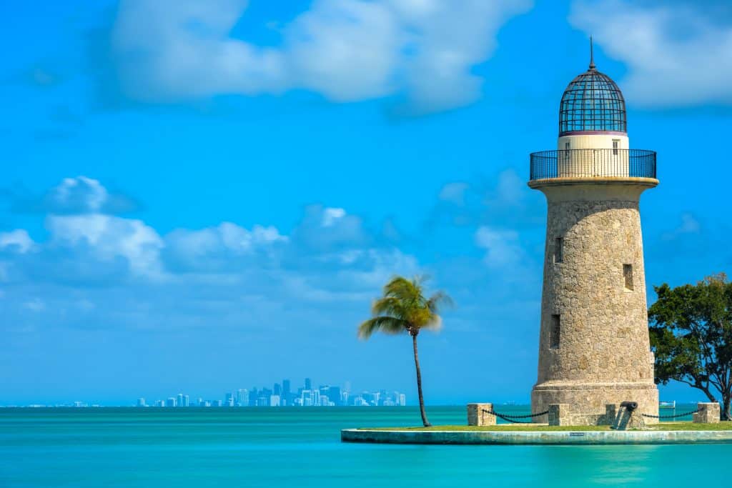 A picture of the lighthouse in bill bags cape state park with the Miami Skyline in the background