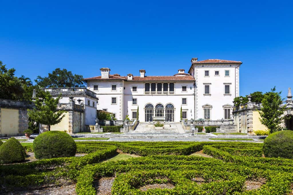 a picture of the vizcaya museum (one of the best places to visit in Miami) in daylight, a large white italian style villa