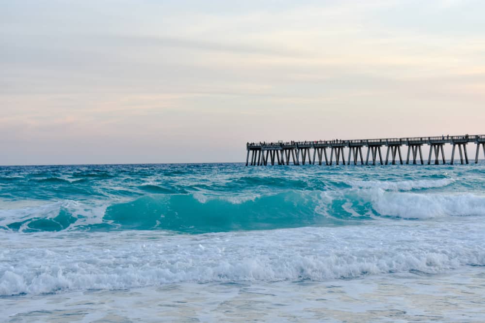 waves at Navarre Beach with the pier in the background.