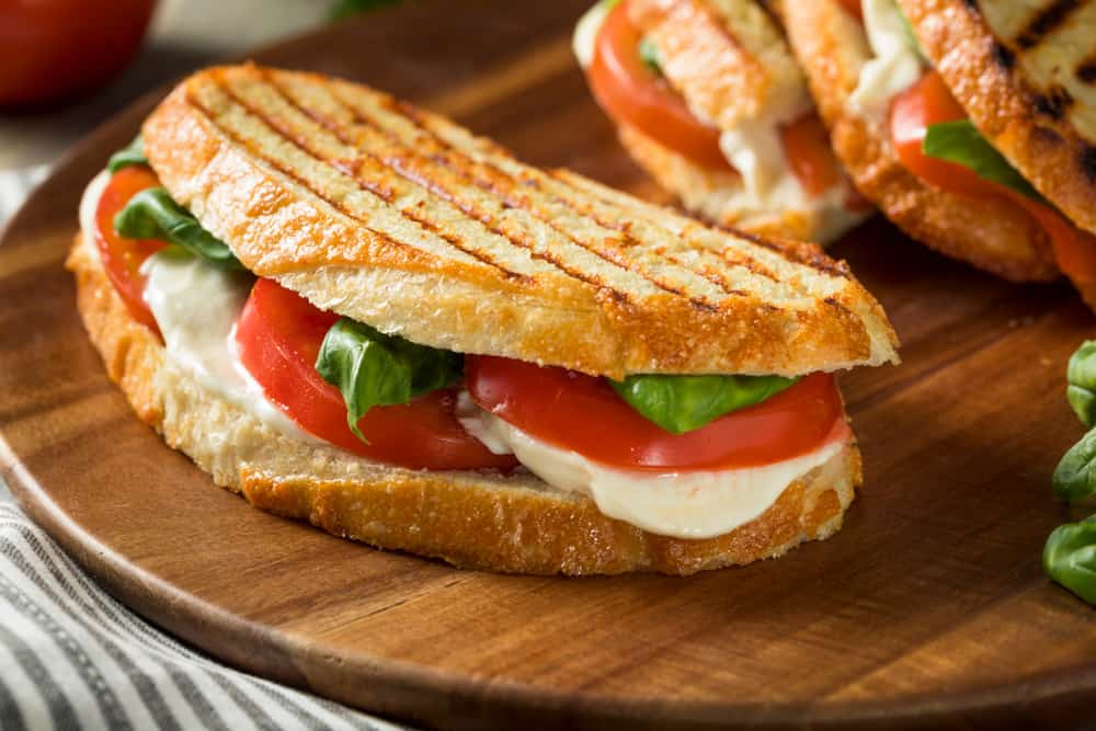 A delicious looking, grilled Caprese sandwich.