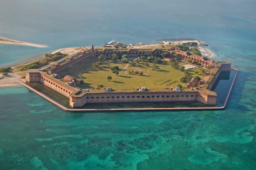 Aerial view of Fort Jefferson on Dry Tortugas National Park surrounded by pristine, blue water.