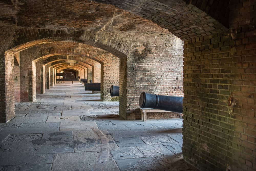 Inside Fort Zachary Taylor with brick arches and cannons.