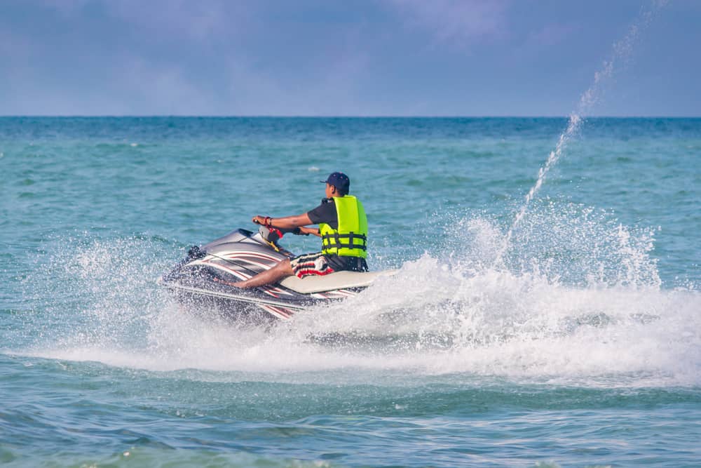 A man out on a jet ski causing waves.