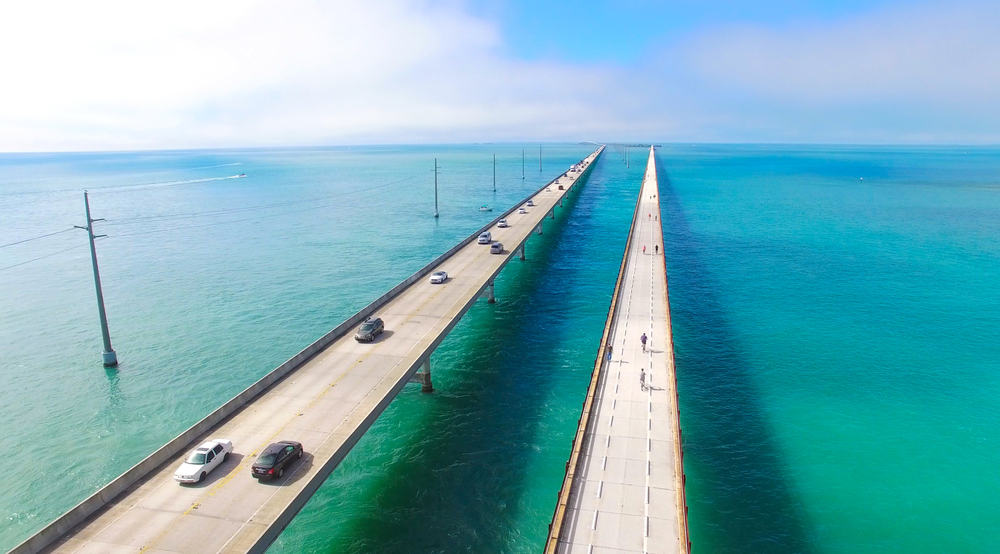 Cars and bikers cross the Seven Mile Bridge, which connects the islands of the Florida Keys.