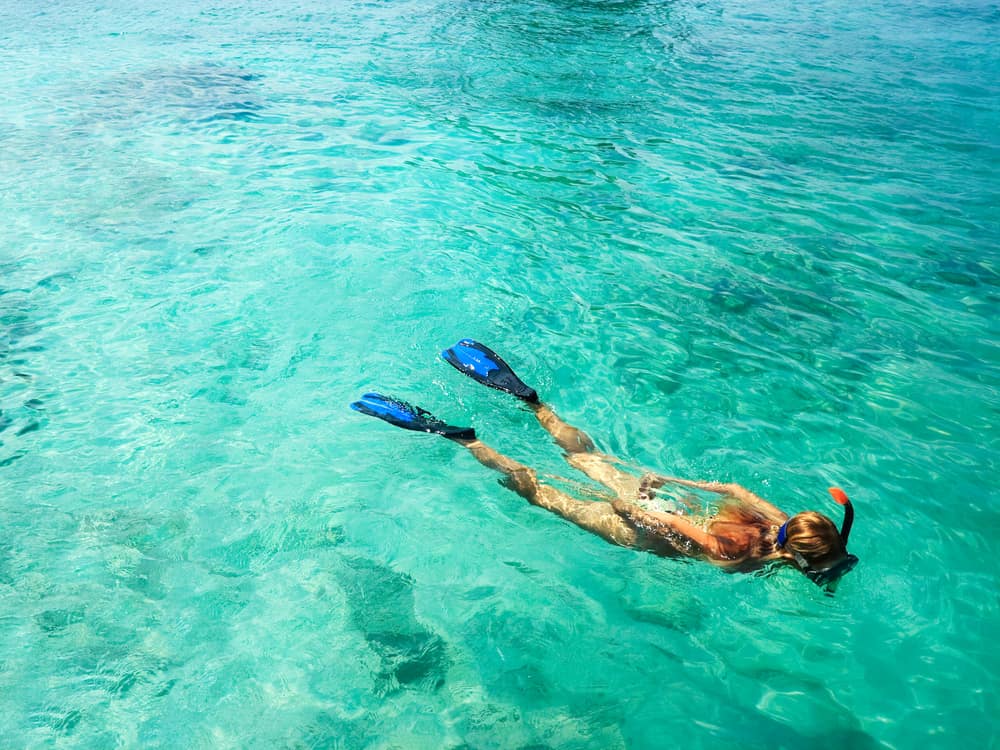 A woman snorkeling in the turquoise waters of Dry Tortugas National Park.