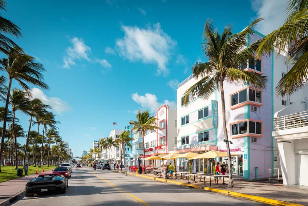 The street Ocean Drive in front of the colorful buildings of the Art Deco Historic District.